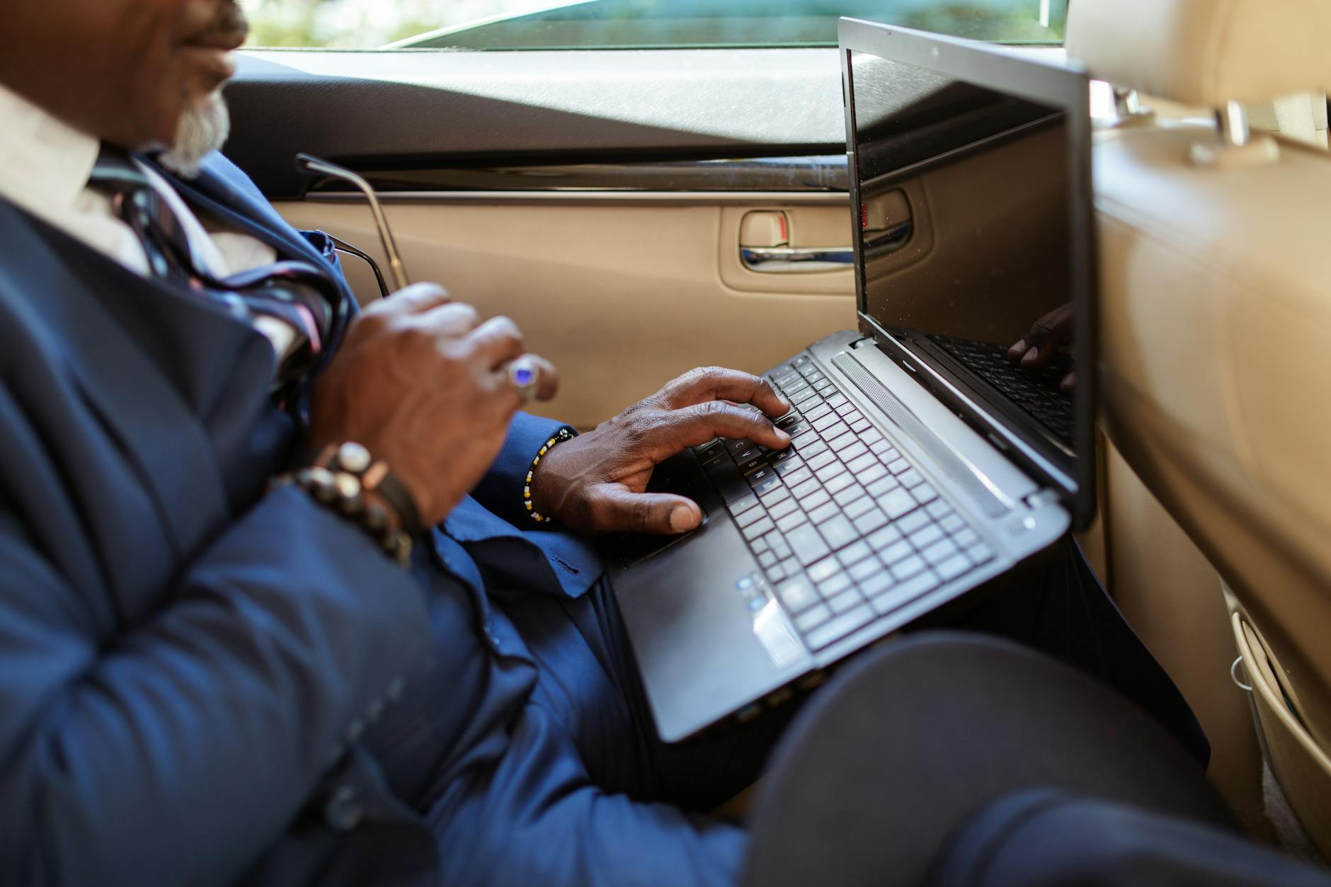 Business executive working on laptop in modern office environment