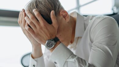 Stressed business executive looking at multiple devices and screens