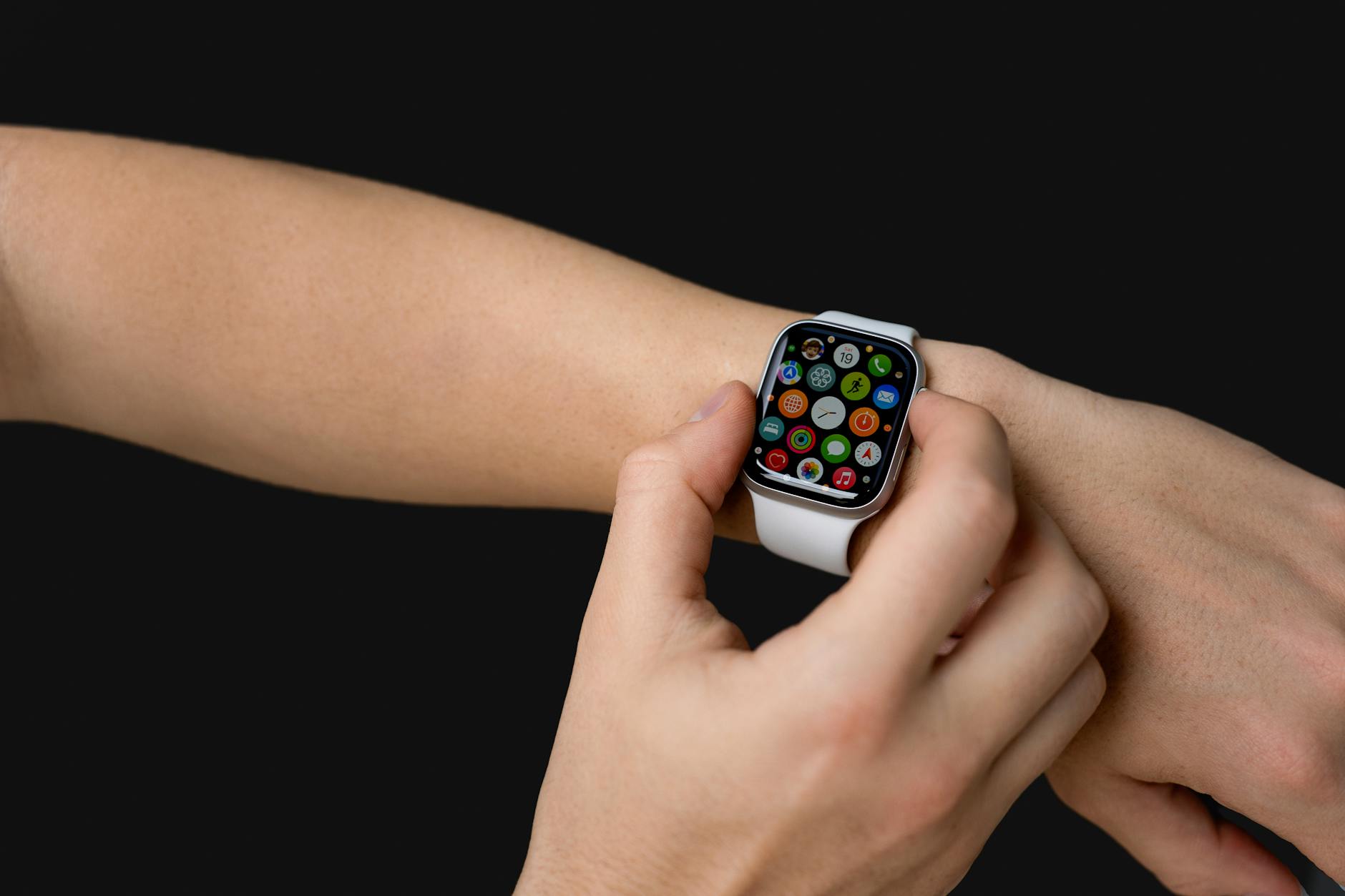 Person wearing smartwatch checking notifications on their wrist at an airport