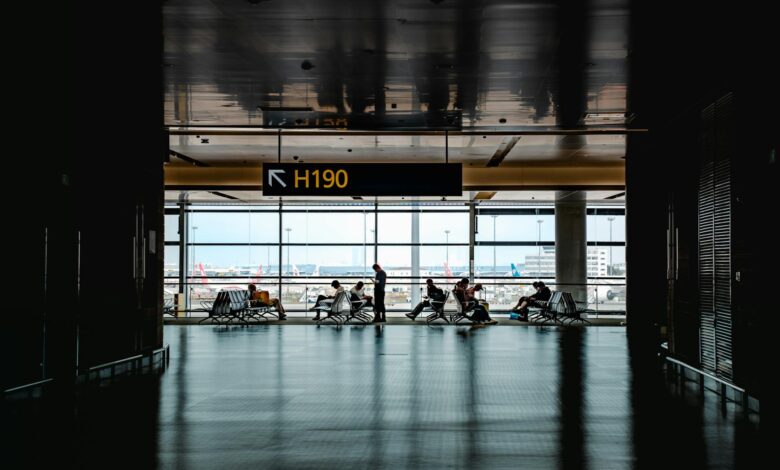Modern airport gate area with seating and departure screens