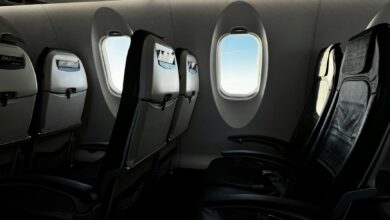 Modern airplane cabin interior showing premium economy seating with extra legroom and enhanced amenities