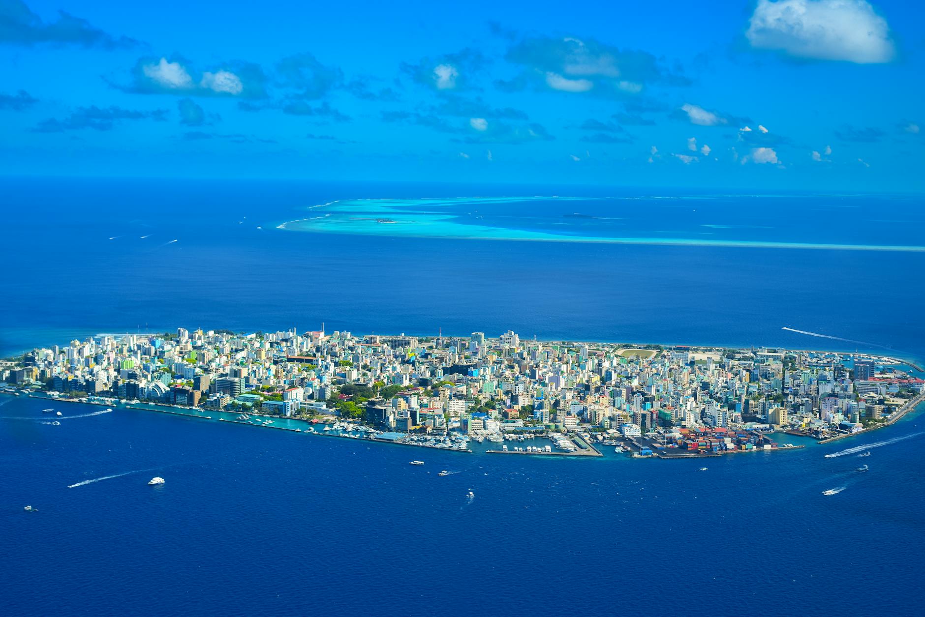 Aerial view of tropical islands surrounded by blue water showing remote island chain geography