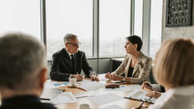 Professional meeting with people in business attire discussing around a conference table