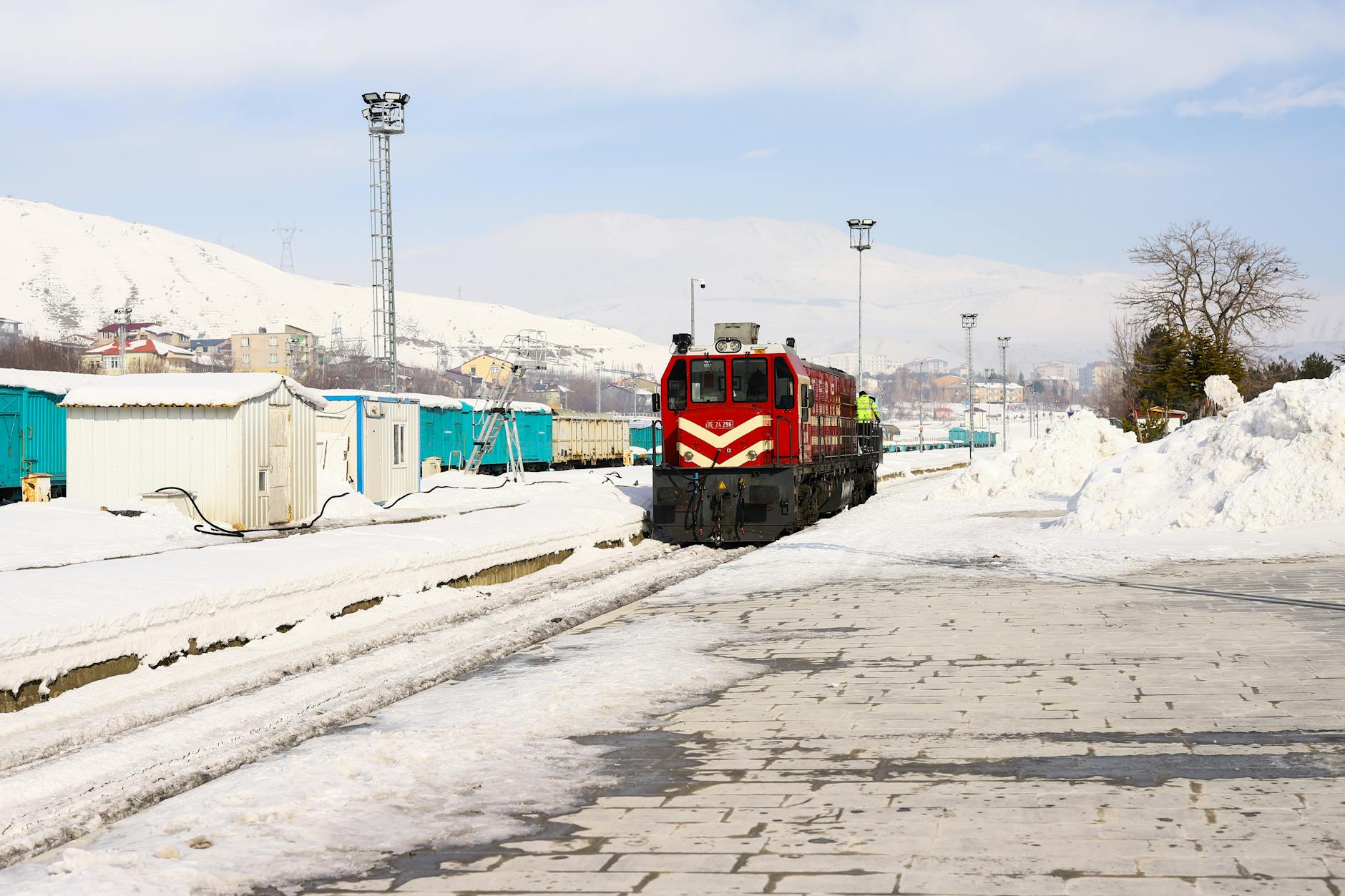 Train traveling through snowy Arctic landscape with snow-covered tracks and winter terrain