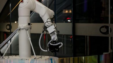 Modern white cylindrical robot in luxury hotel hallway ready for guest room delivery service