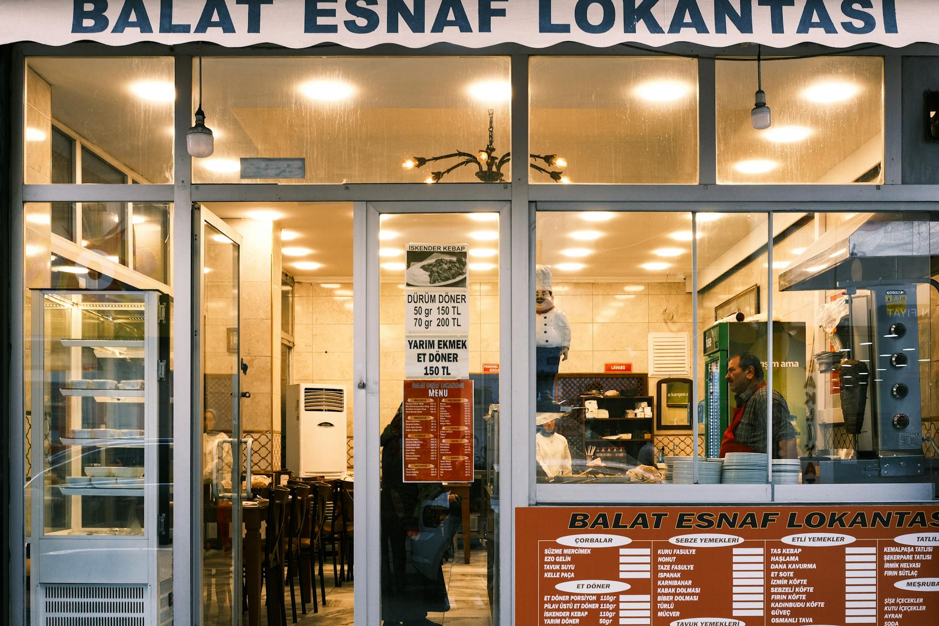Simple restaurant interior with basic tables and chairs showing authentic local dining atmosphere