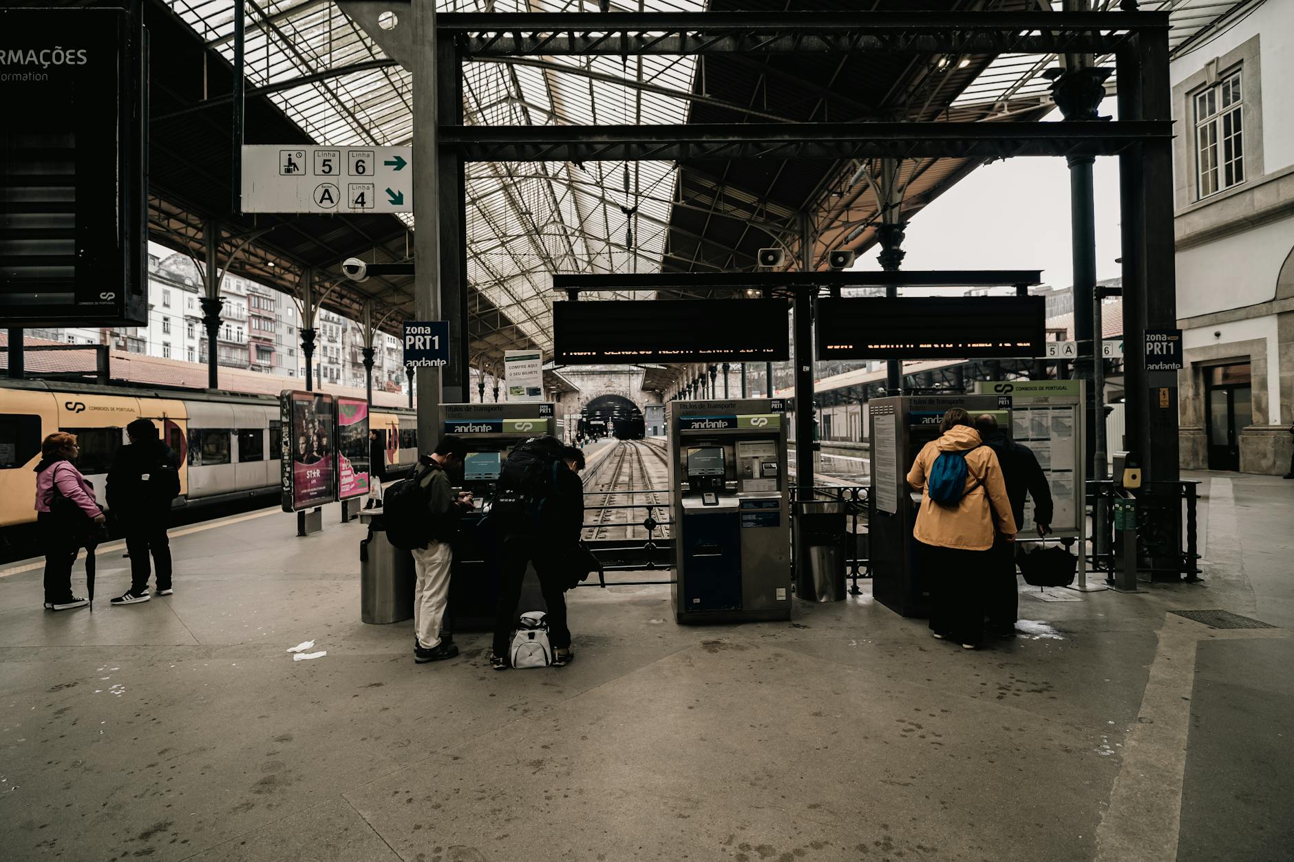 European train station platform with modern high-speed trains and travelers with luggage