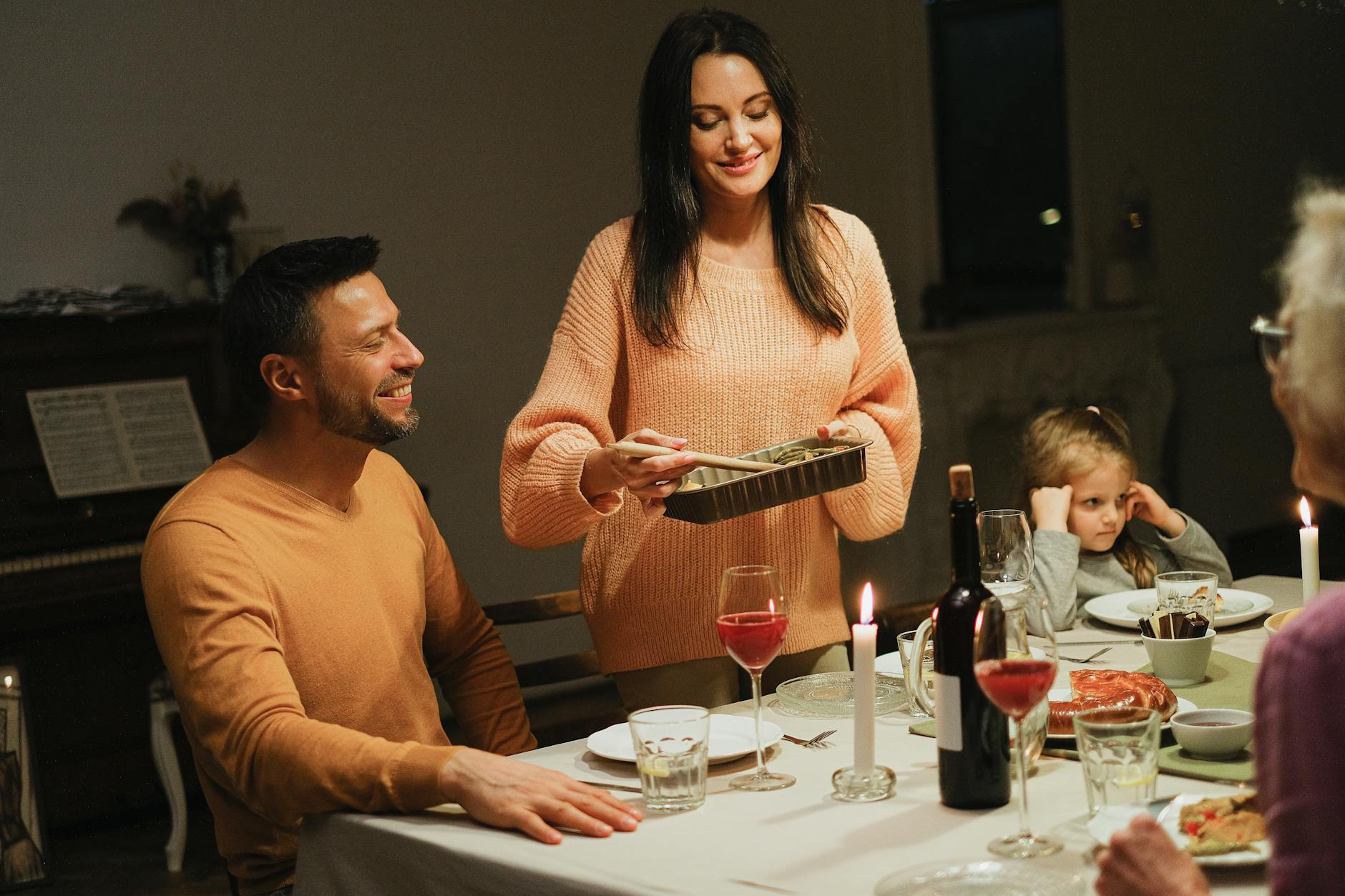 Family gathered around dinner table without phones for quality conversation time