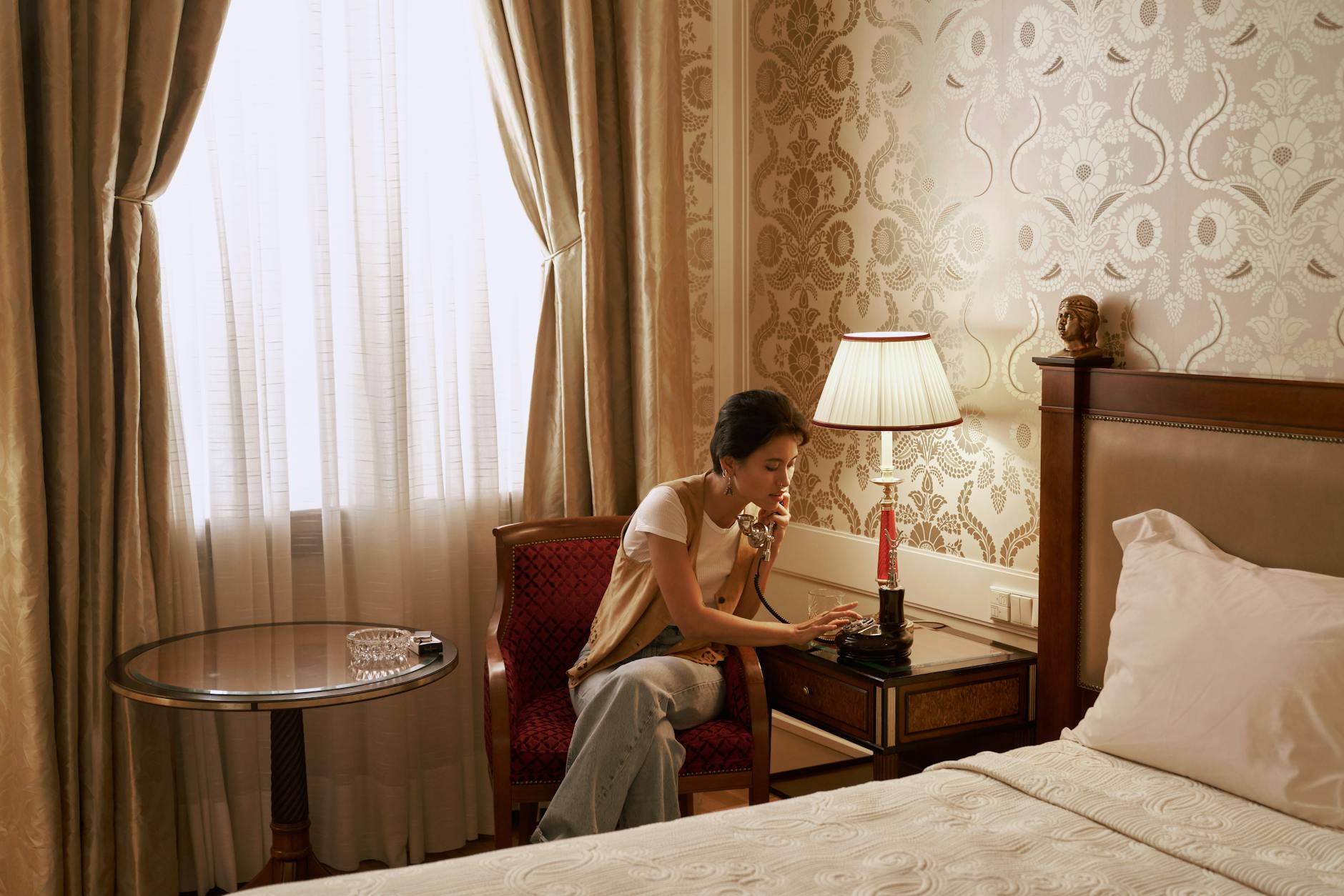 Person using smartphone to book hotel room with mobile app interface visible