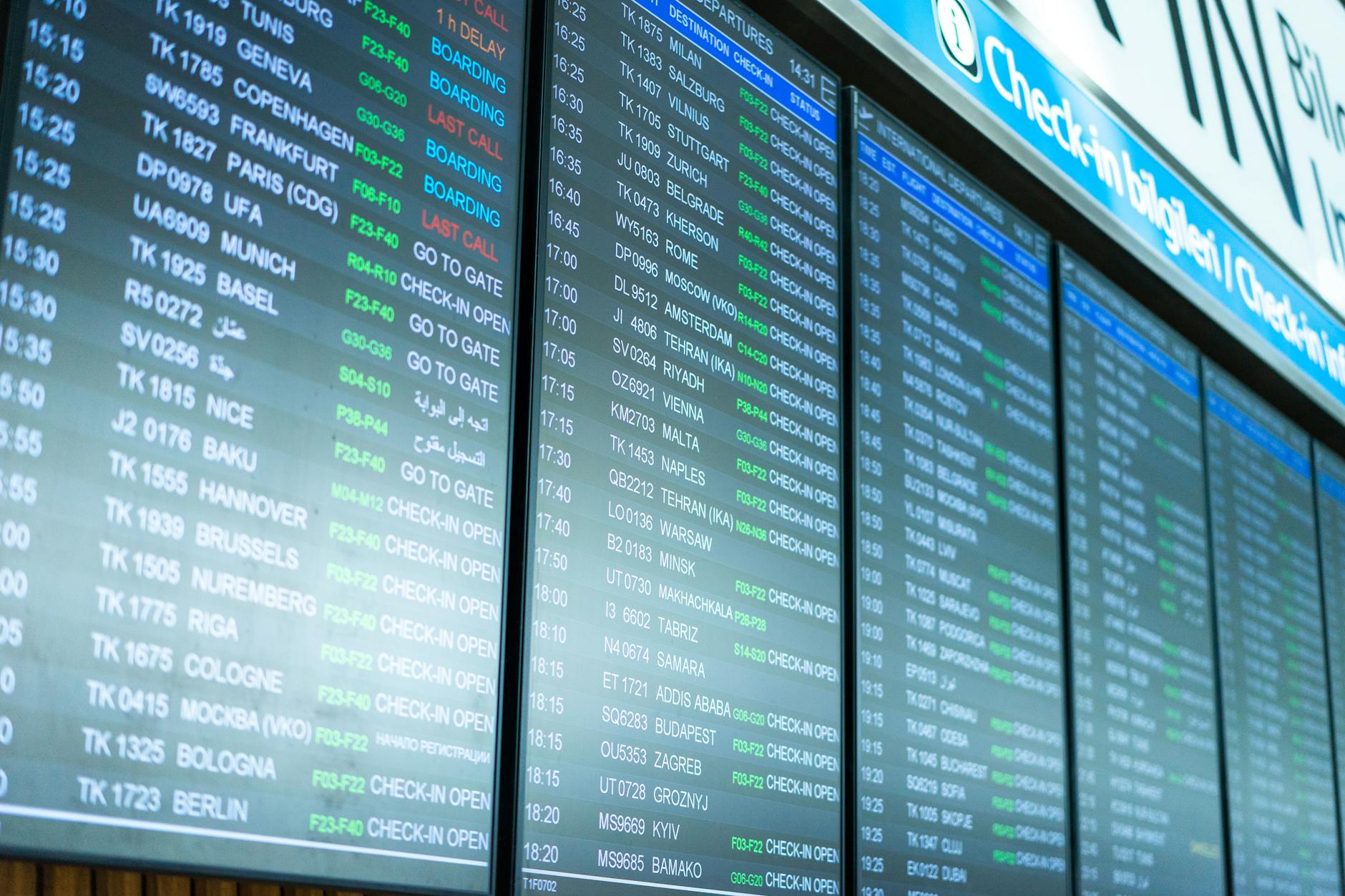 Digital airport departure board showing multiple international flight destinations and times