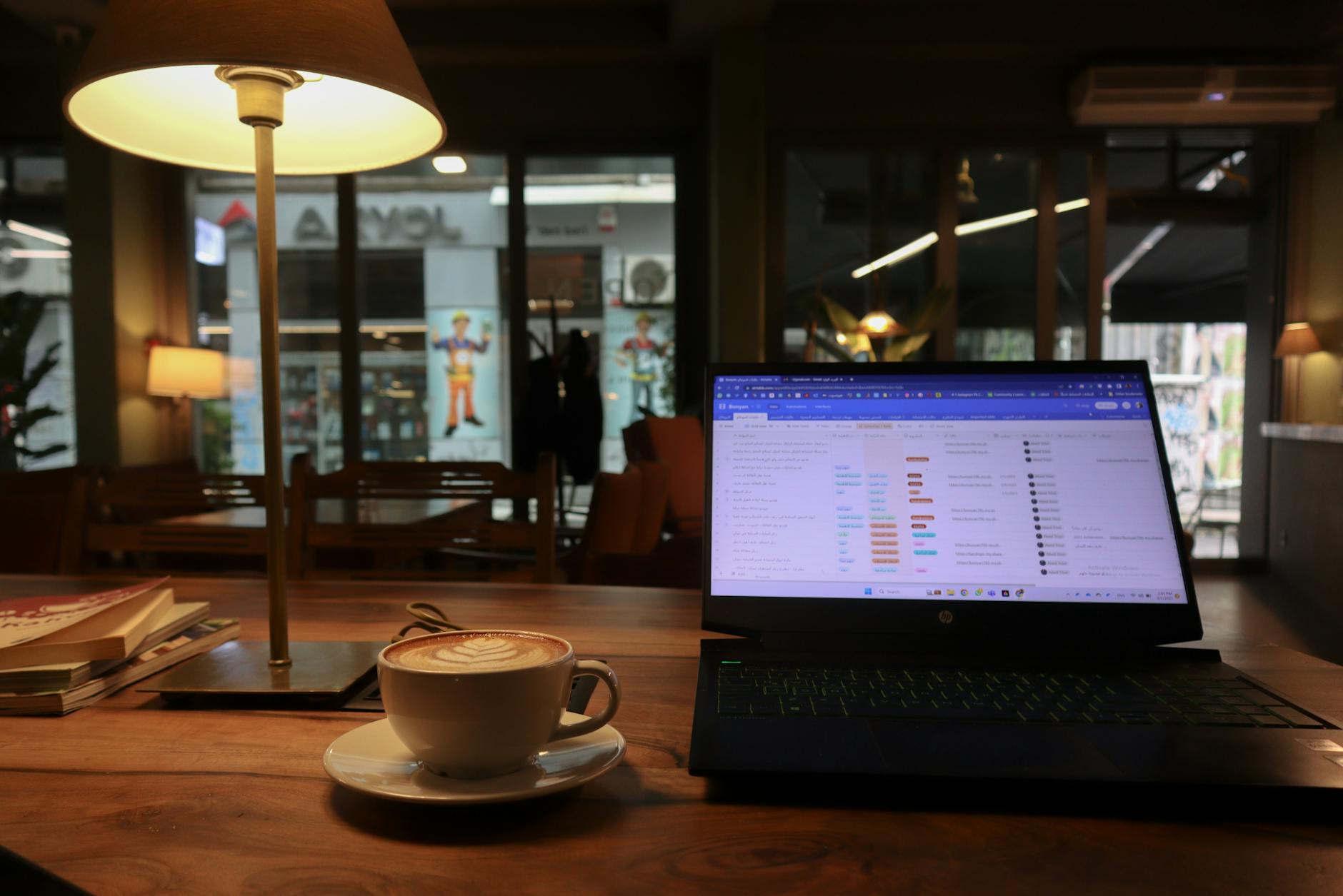 Person working on laptop in coffee shop with WiFi connection