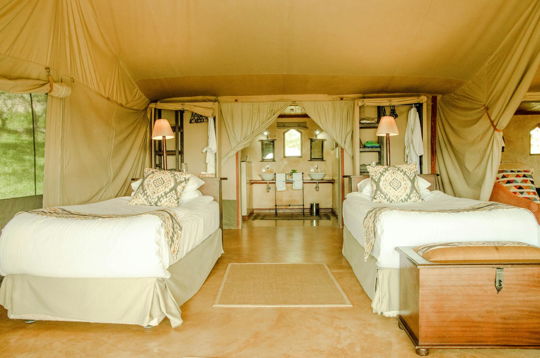 Elegant glamping tent with transparent roof setup in desert environment at dusk