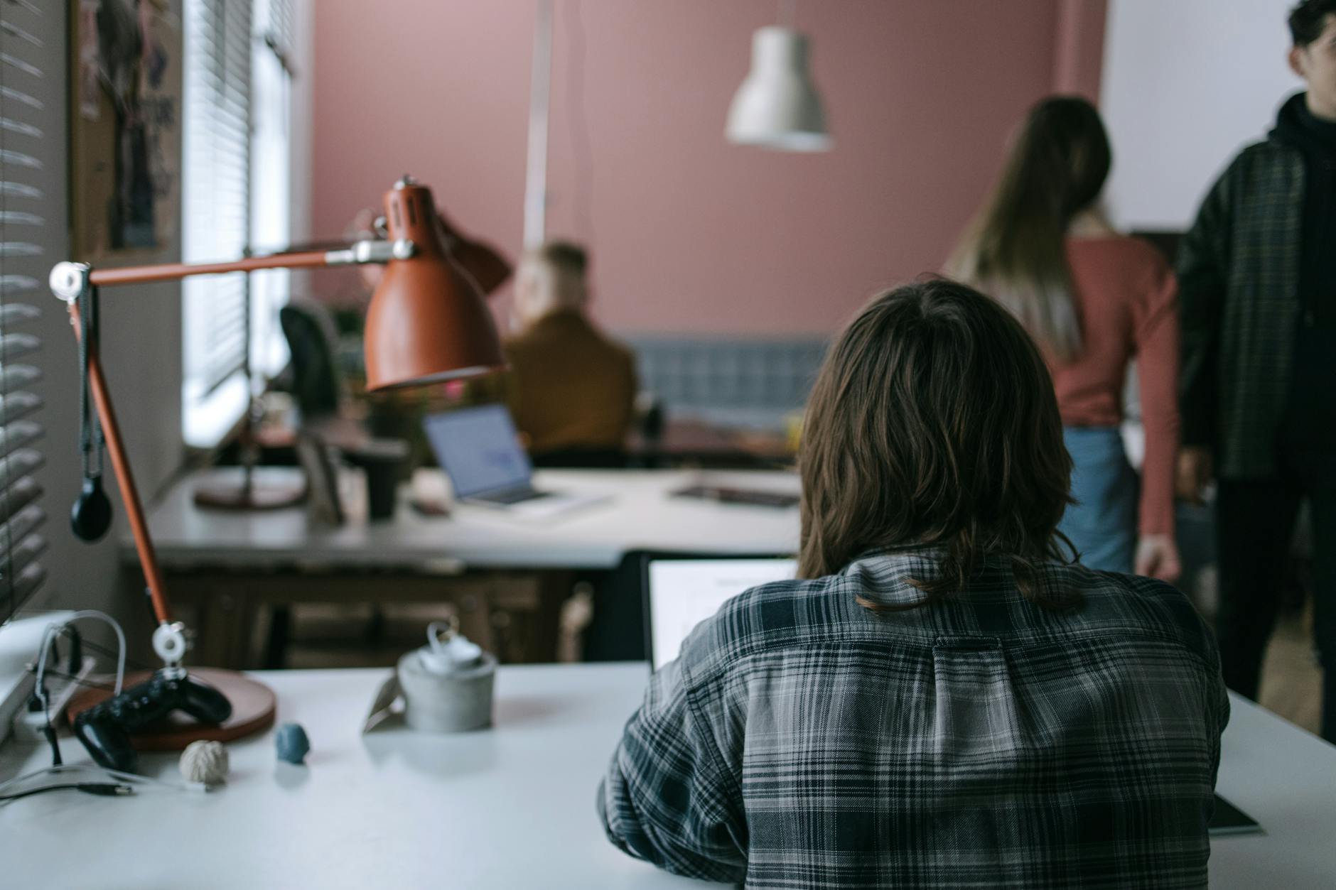 Modern coworking space with people at desks supporting digital nomad infrastructure