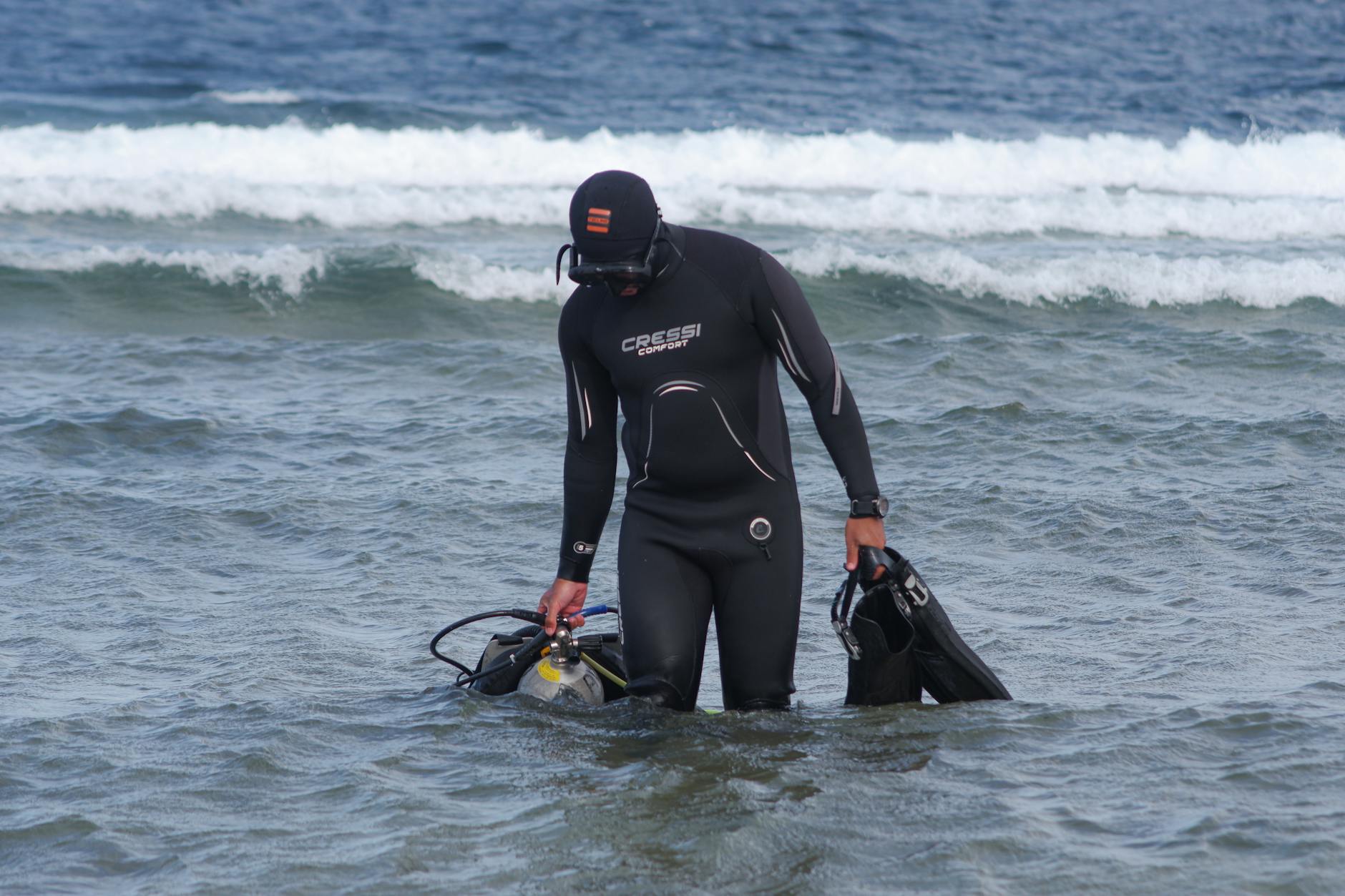 Professional diving equipment and gear laid out for technical cave diving exploration