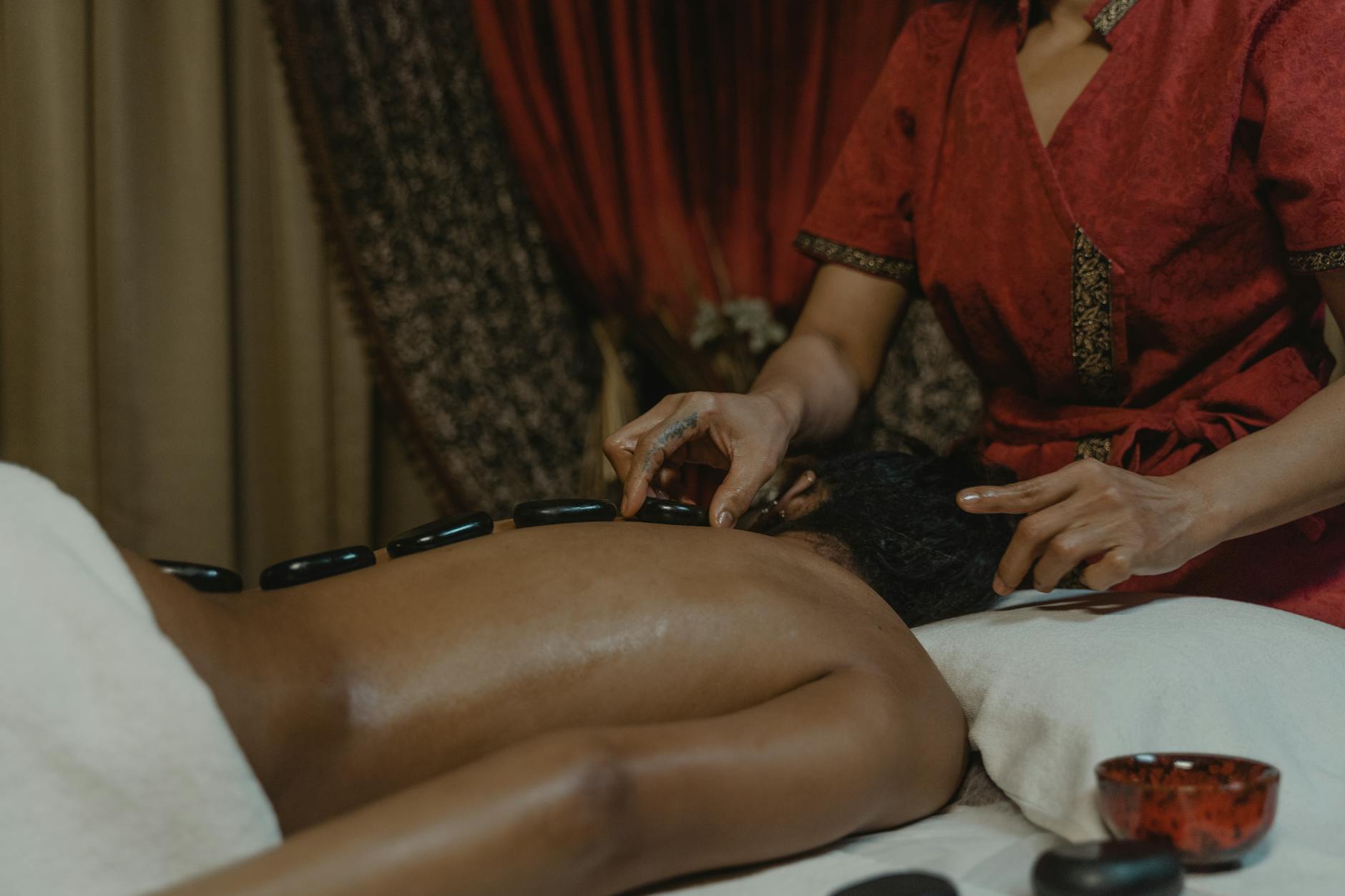 Heated volcanic stones arranged for spa therapy treatment
