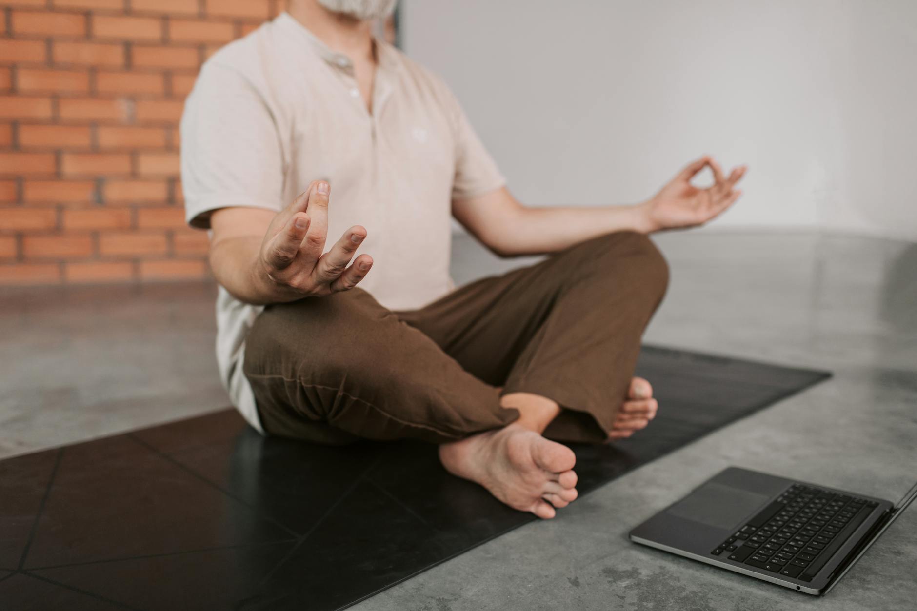 Business professional in suit practicing meditation or mindful breathing in office setting