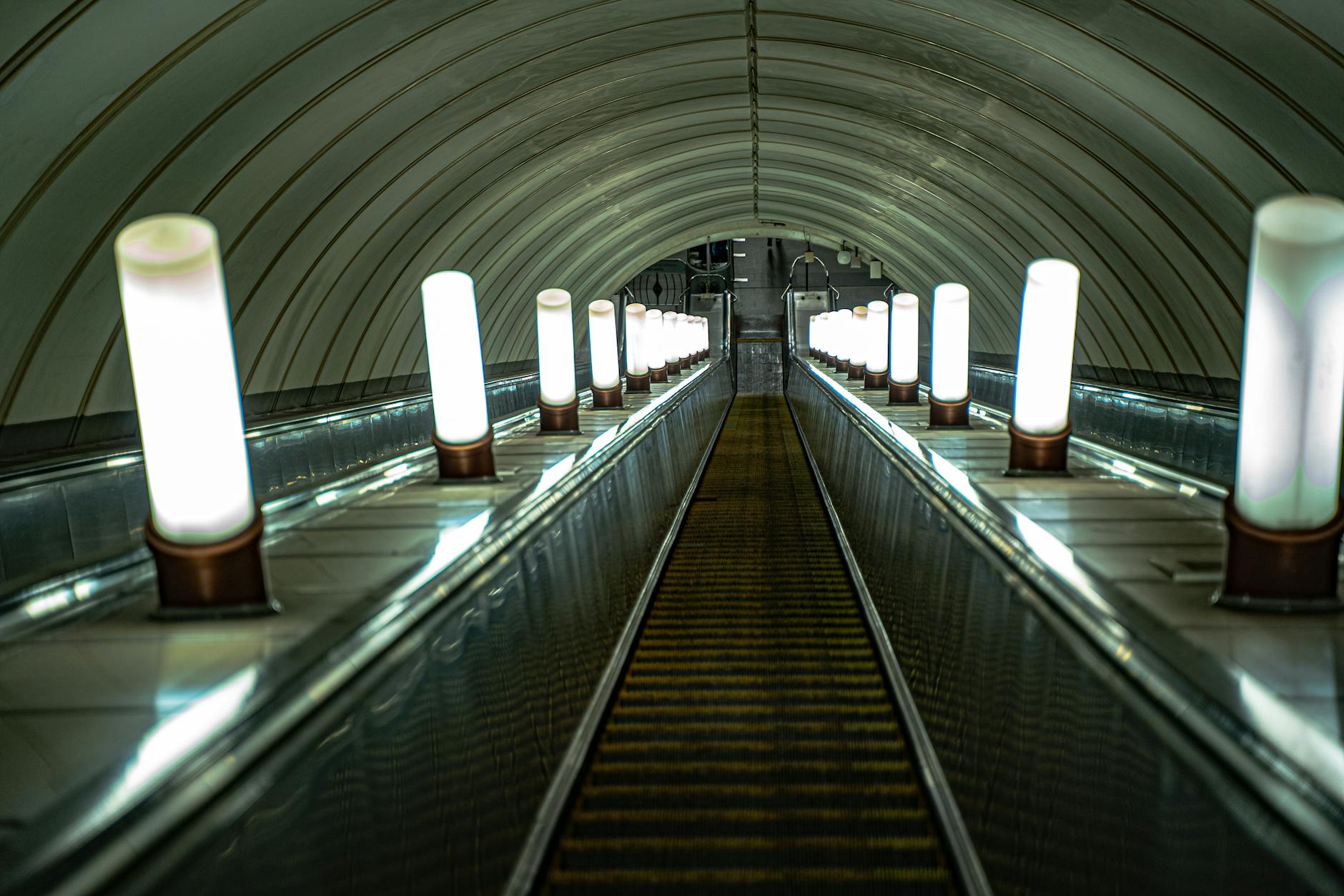 Modern underground tunnel with large glass windows and comfortable seating area