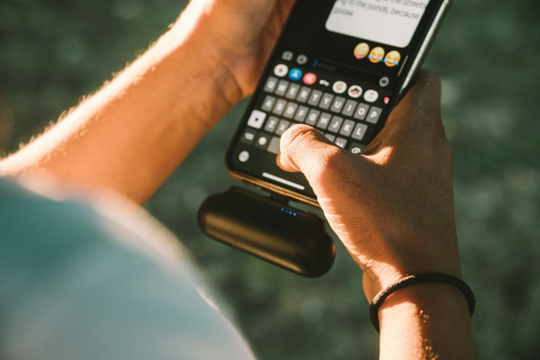 Smartphone charging with portable power bank on travel desk