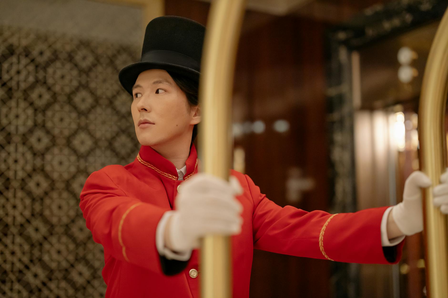 Professional hotel concierge staff member assisting guests at luxury property reception desk