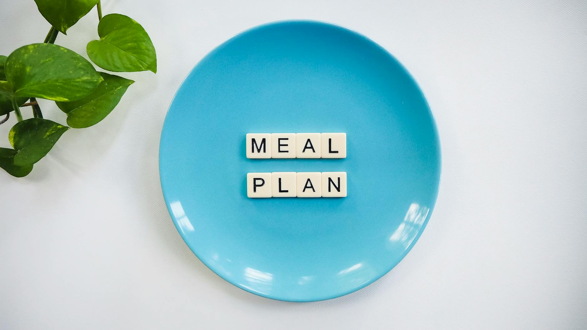 Organized meal planning notebook with fresh ingredients and kitchen tools