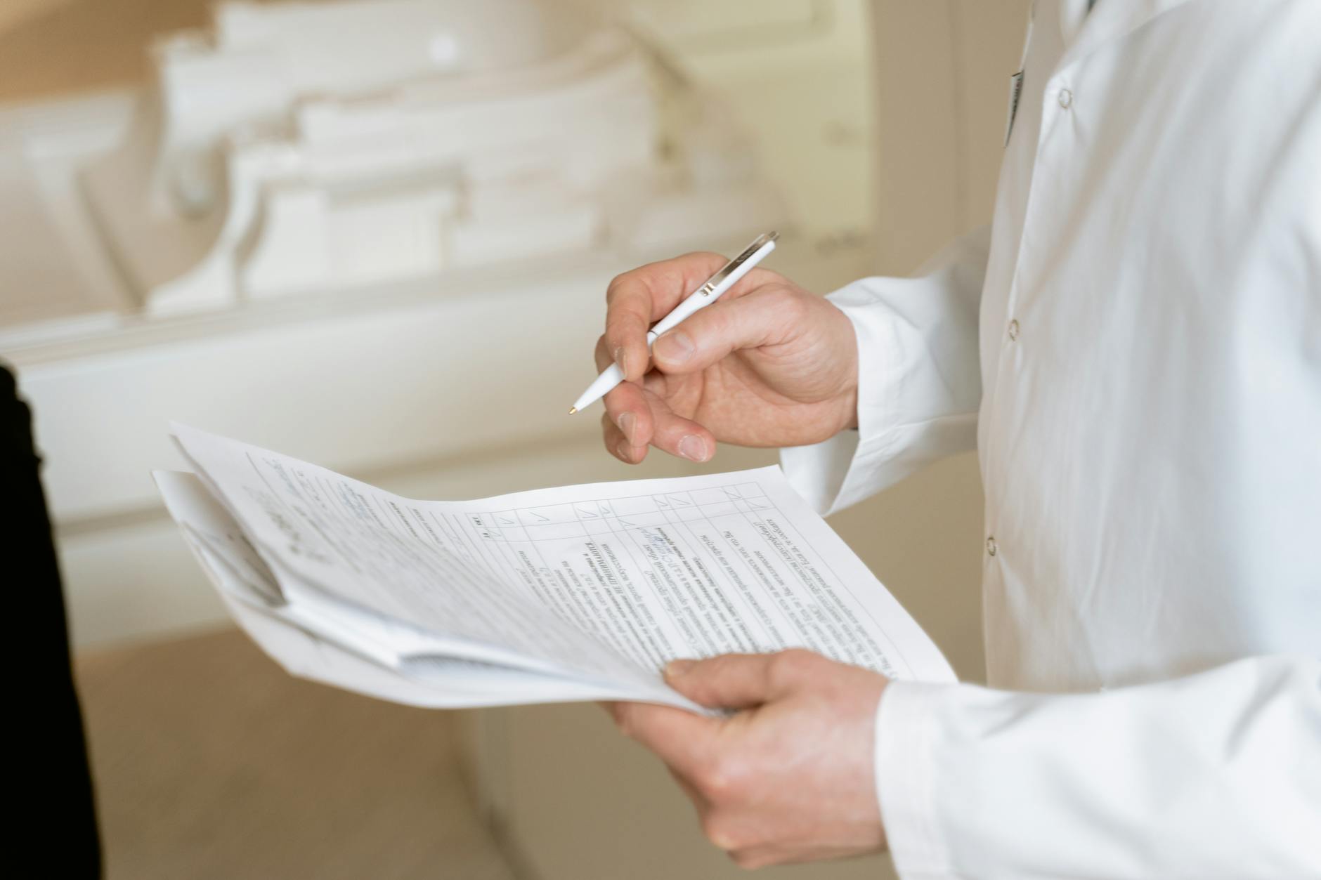 Medical documentation and prescription papers spread on desk with pen