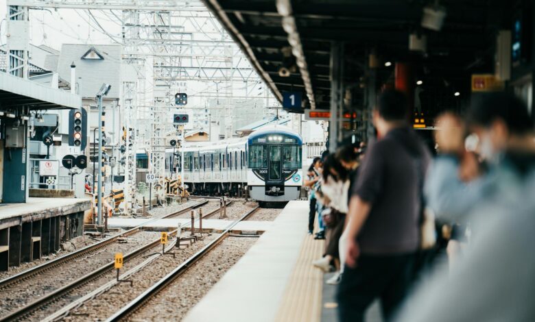 Modern train station platform with overhead canopy and railway tracks extending into the distance