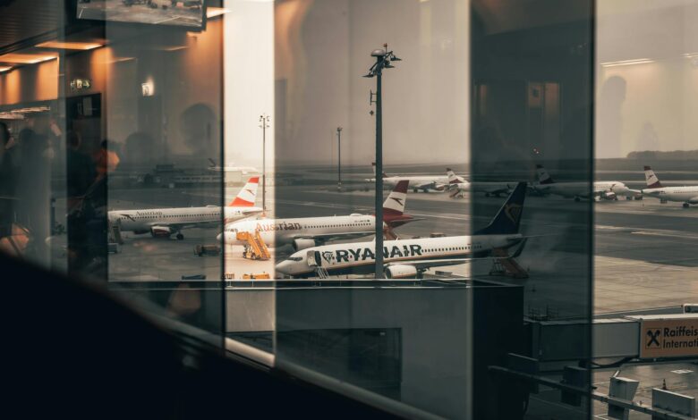 Modern airport boarding gate with passengers and electronic displays