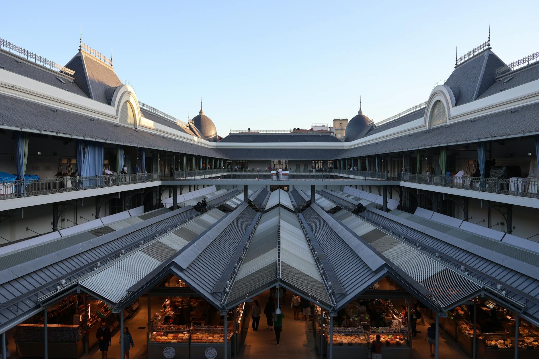 Spacious food hall with multiple cooking stations and communal dining tables
