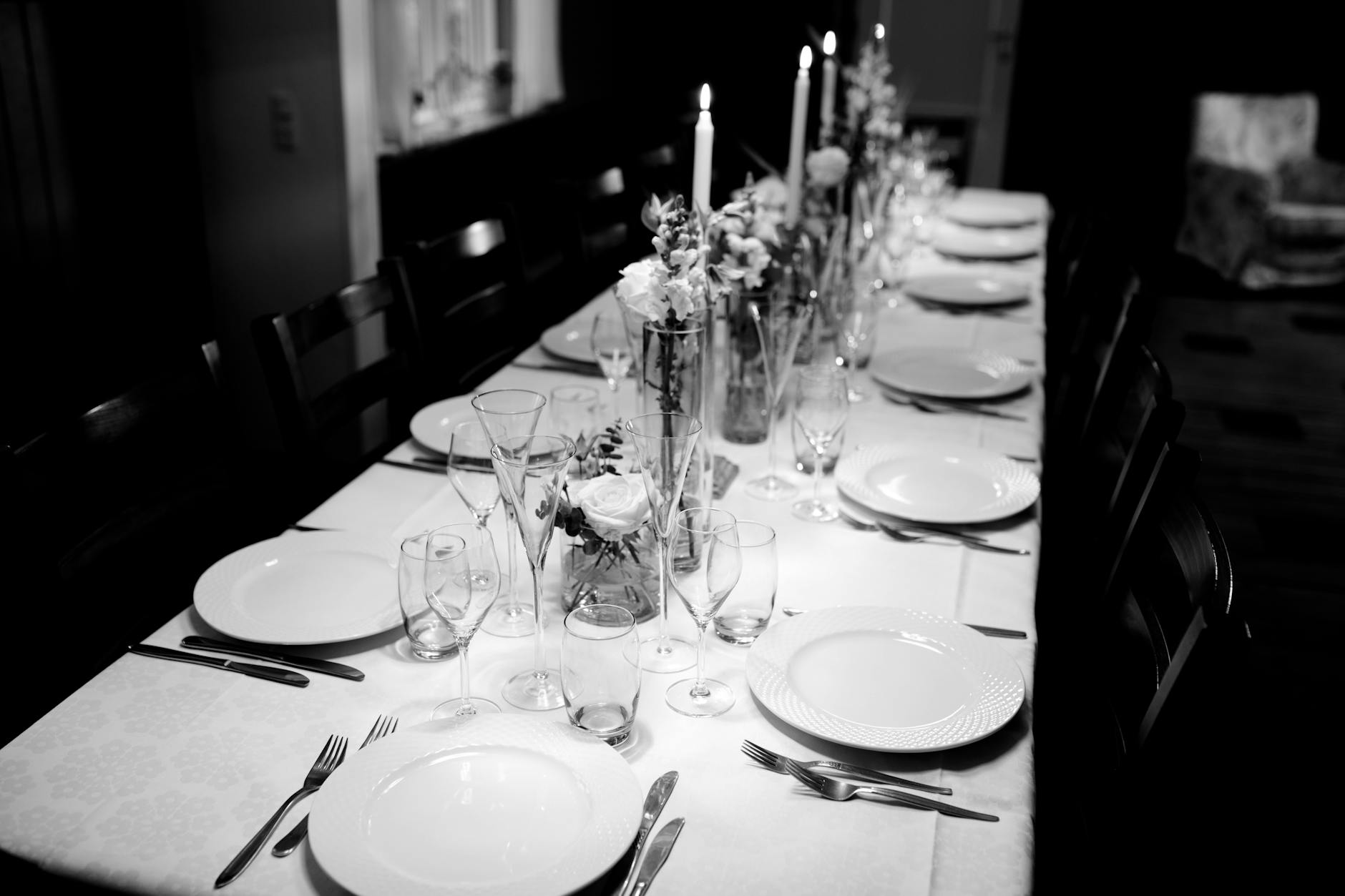 Elegant formal dining table setting with wine glasses and fine china