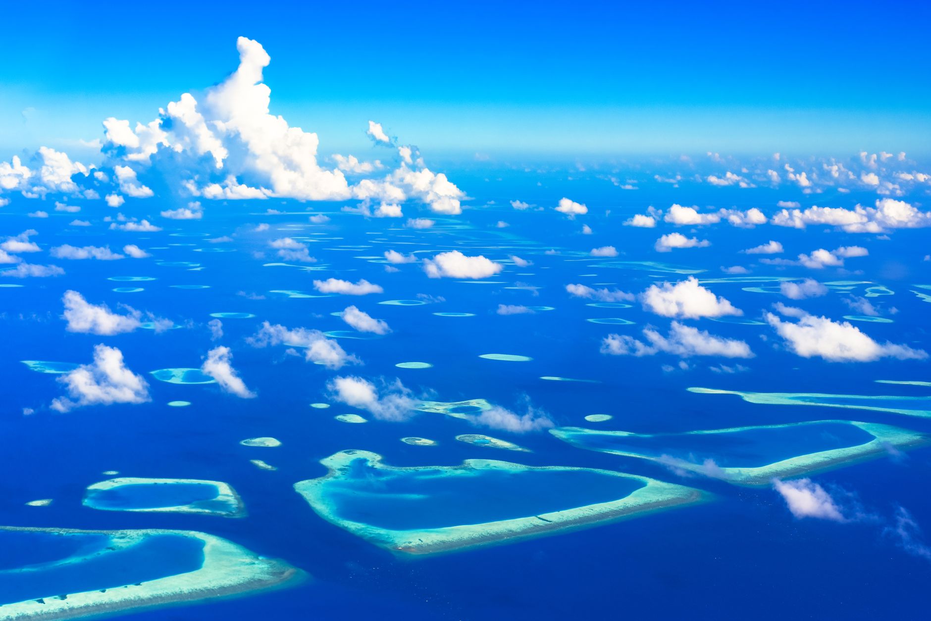 Aerial view of a remote tropical island surrounded by turquoise ocean water