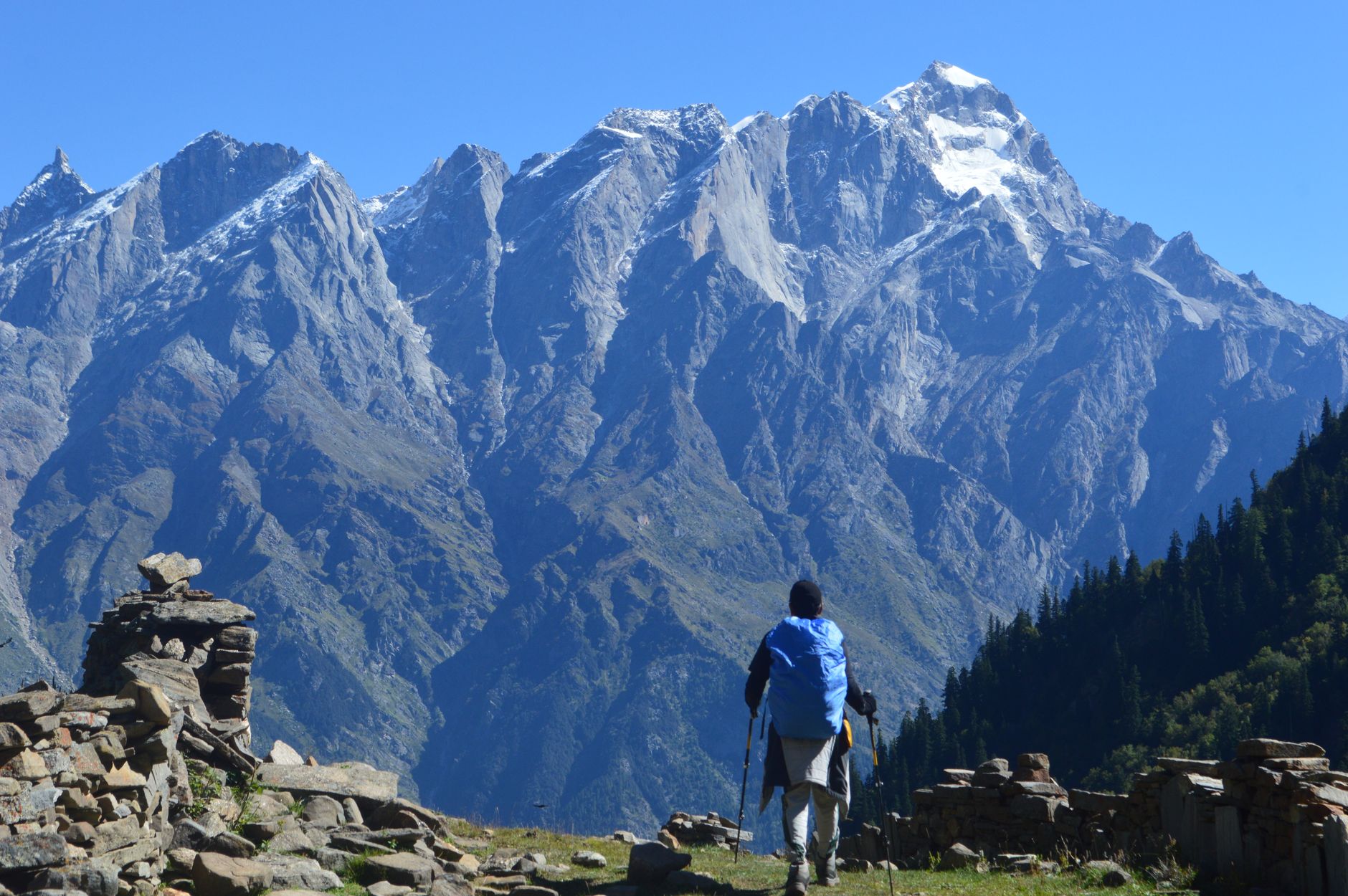 Trekker descending a steep mountain trail in the Peruvian Andes at sunrise