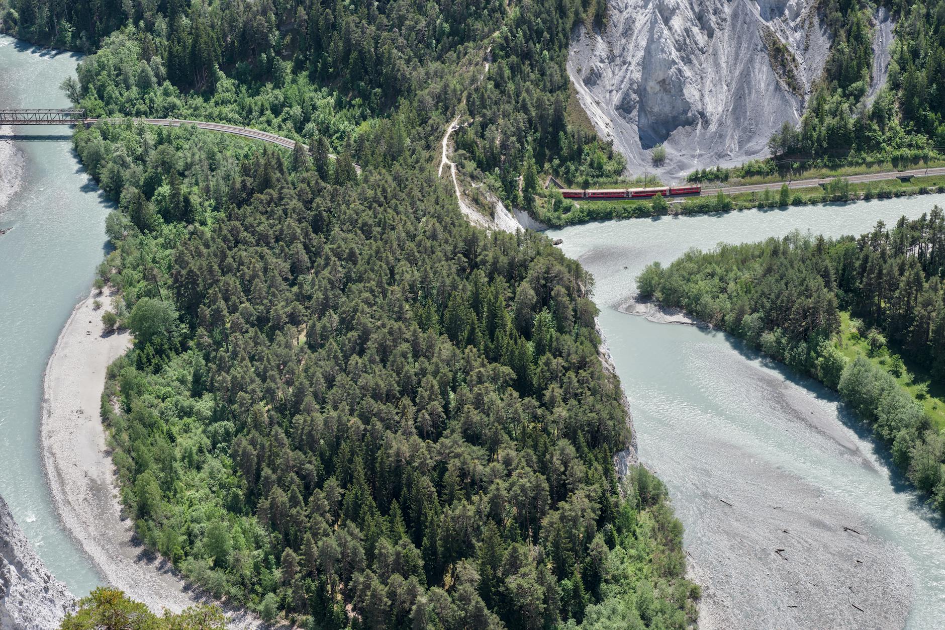 Aerial view of a deep river gorge with turquoise water surrounded by rugged limestone cliffs