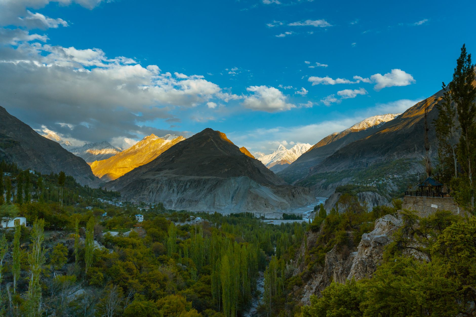 Sweeping view of a high-altitude valley surrounded by snow-capped Karakoram peaks in northern Pakistan
