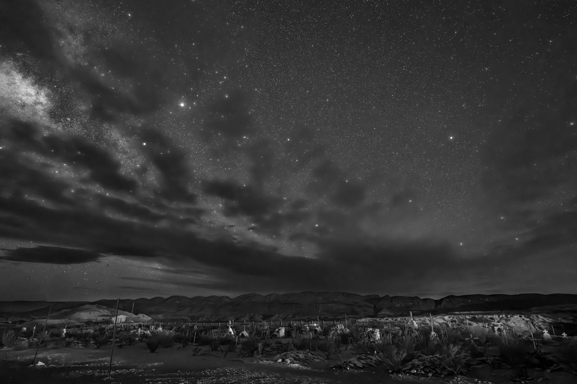 Starry night sky over the Atacama Desert with the Milky Way visible above a dry landscape