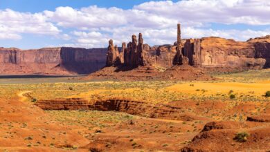 A remote high-altitude desert valley with dry mountains and a winding river below