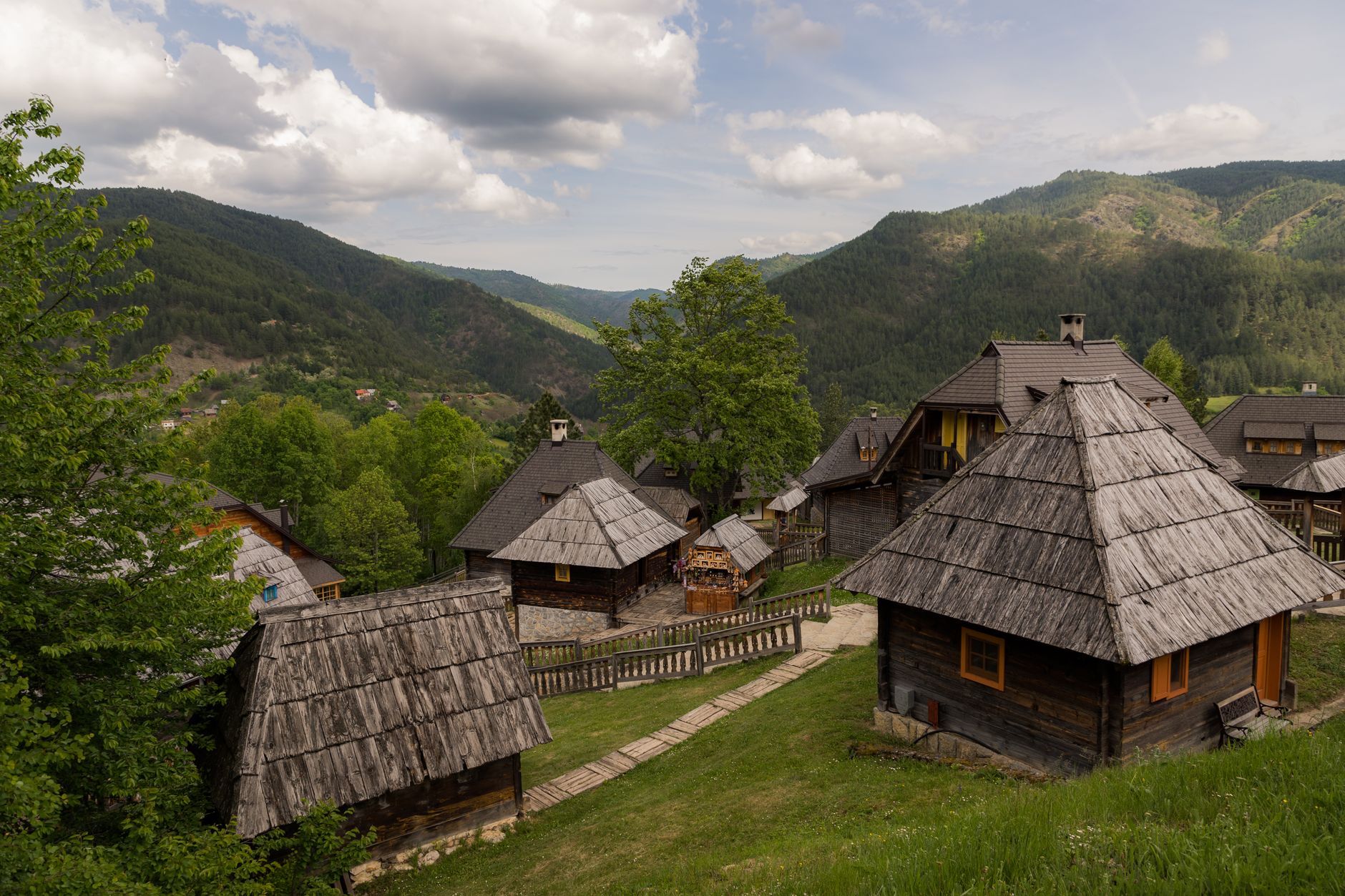 Traditional wooden village houses on a green mountain plateau in Serbia