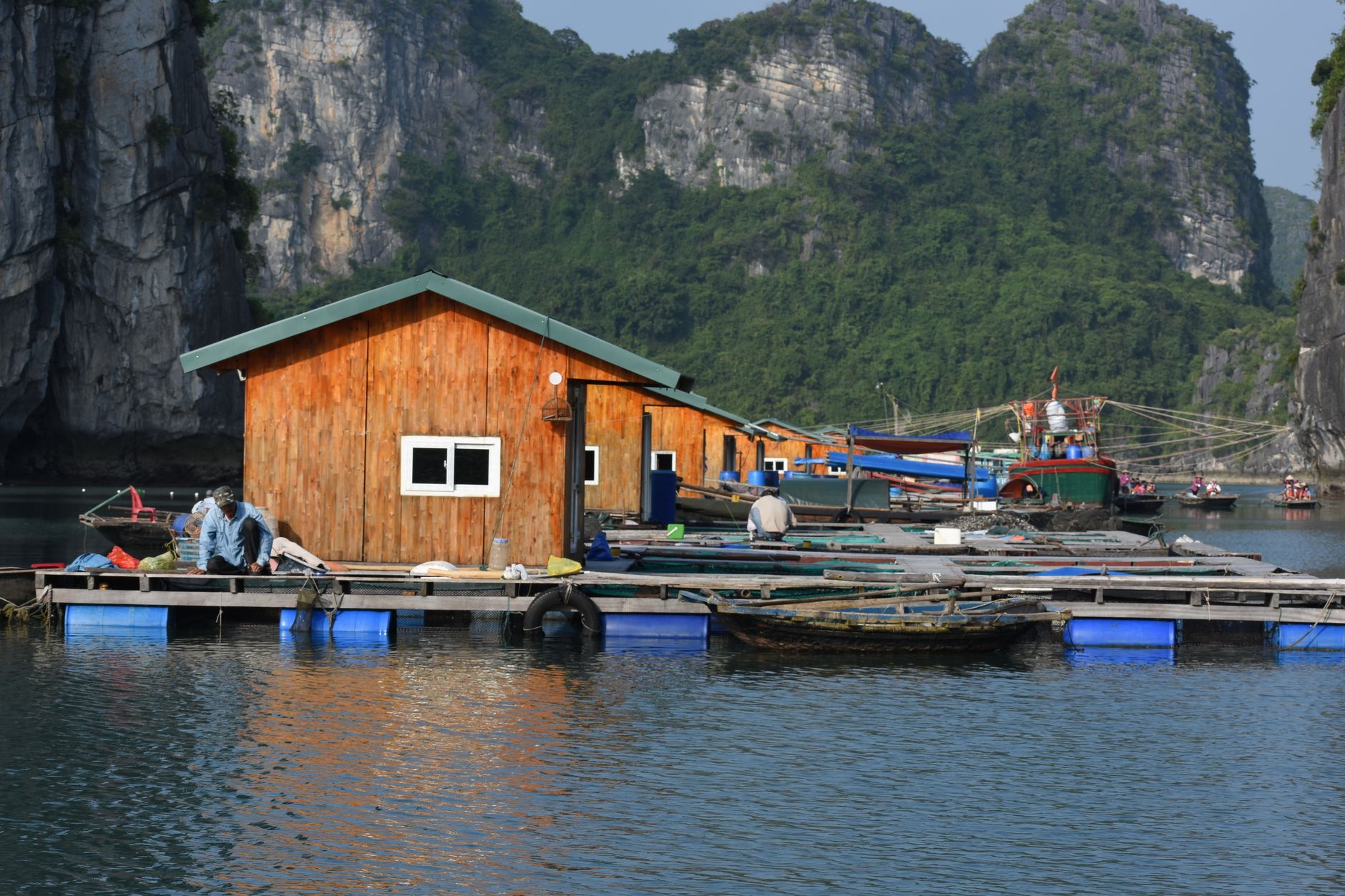 Stilted wooden houses over calm lake water in a traditional floating village