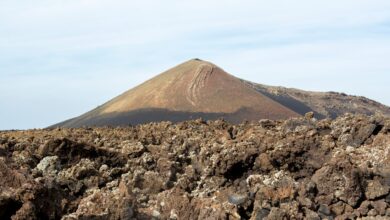 Colorful hydrothermal pools and sulfur formations in a volcanic depression landscape