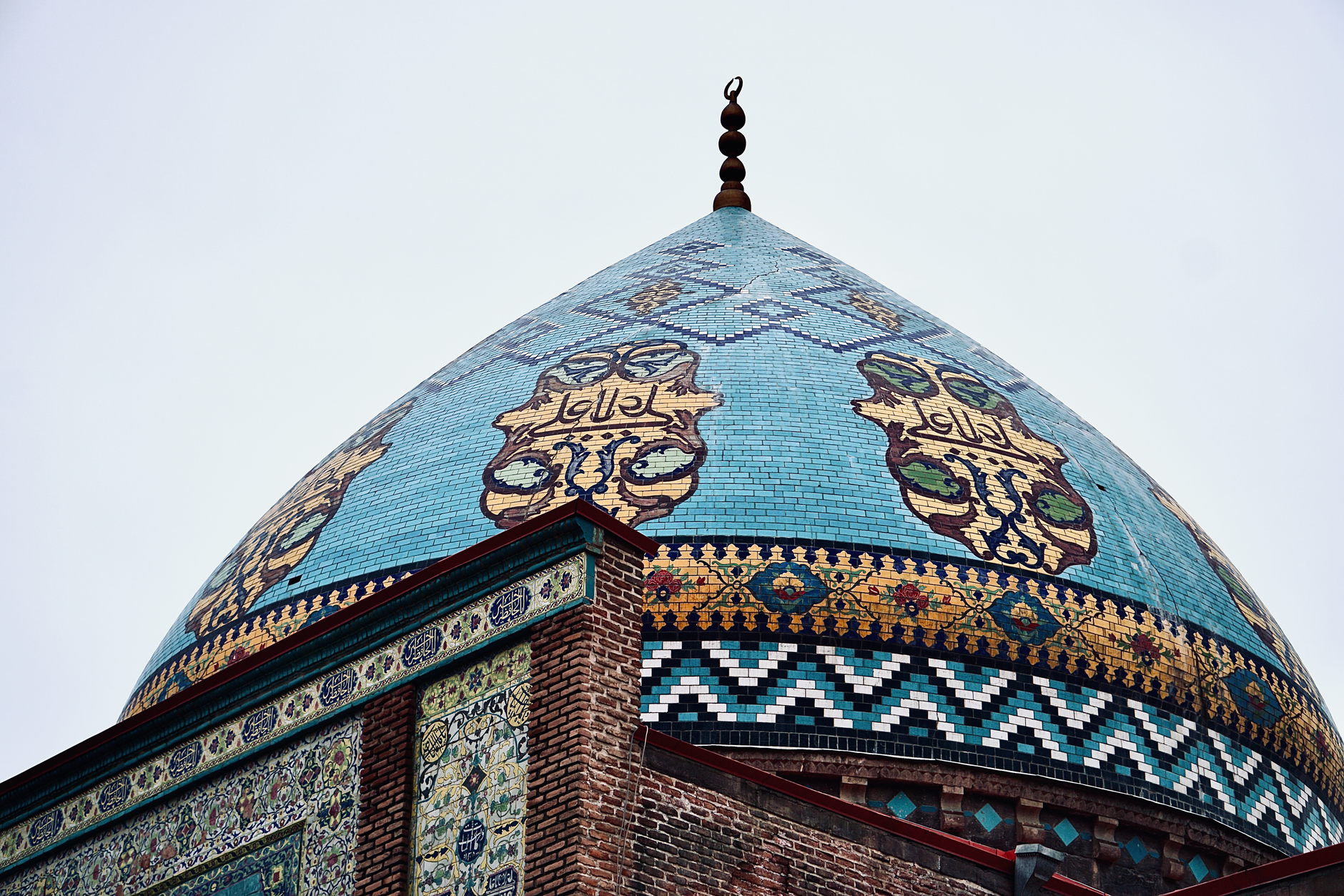 Intricate blue and turquoise tilework on the exterior of a Persian mosque in Isfahan, Iran