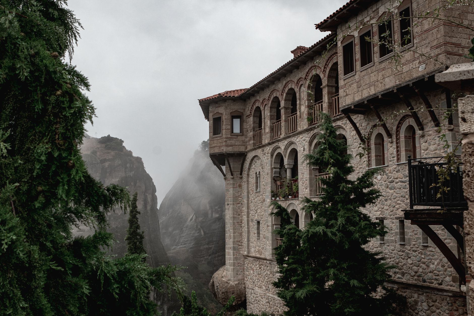 Ancient stone monastery surrounded by thick forest in the Armenian highlands