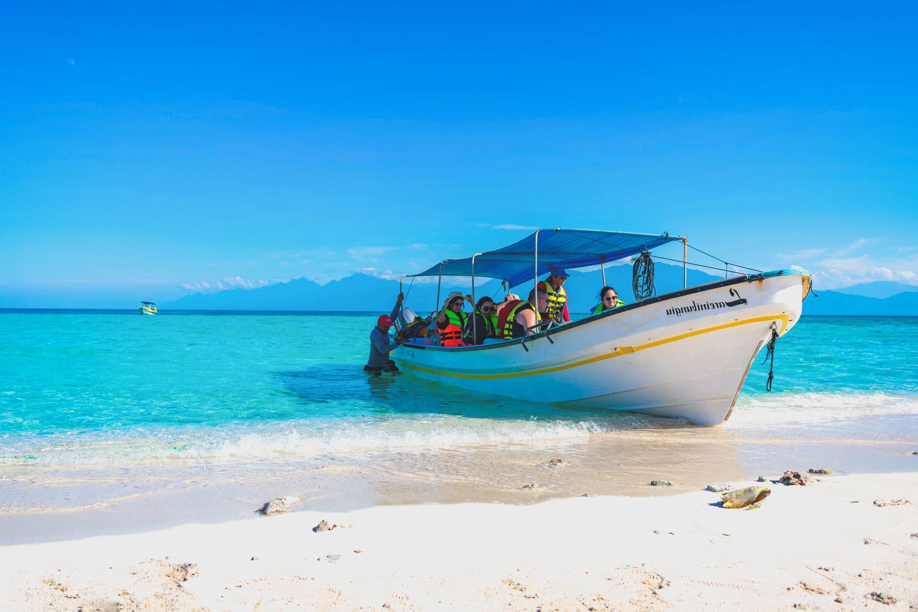 Small boat with passengers on a quiet lagoon during a guided wildlife tour