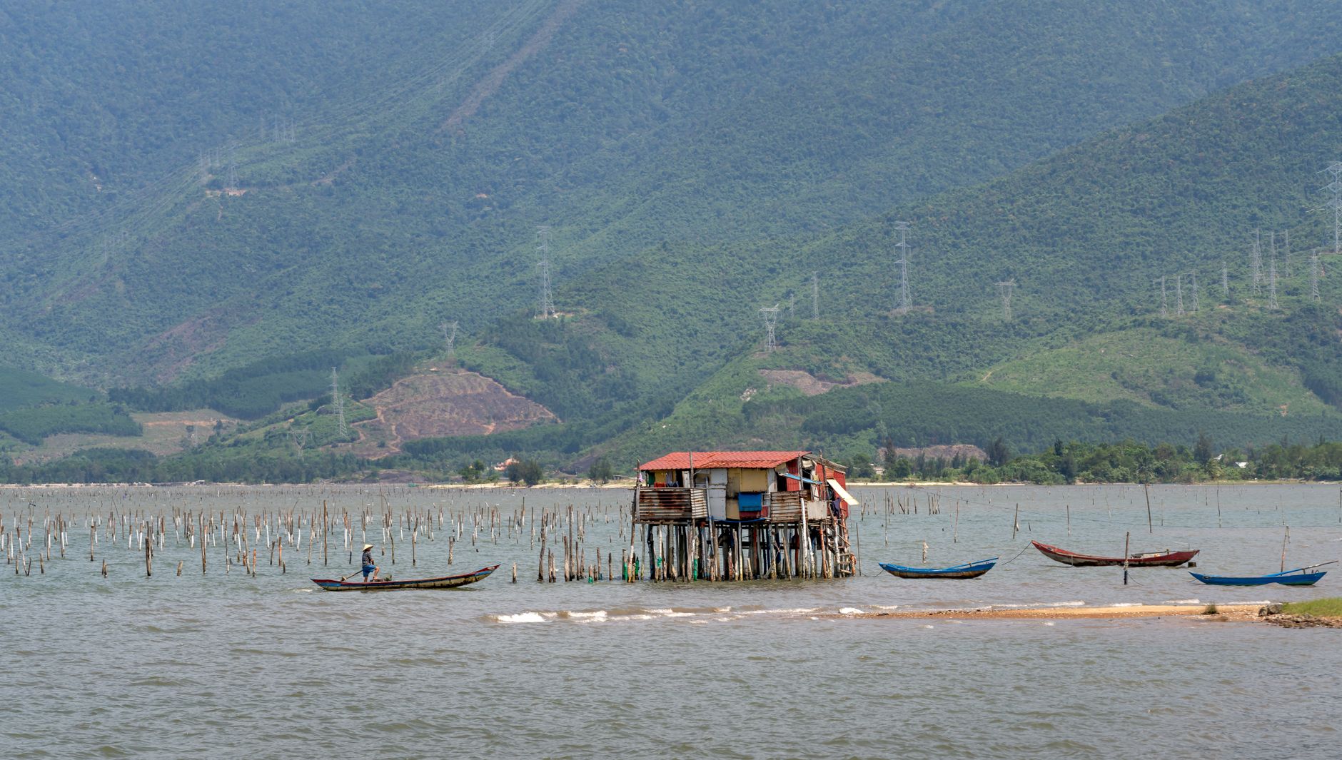 Traditional fishing village on the shore of a large African lake with dugout canoes