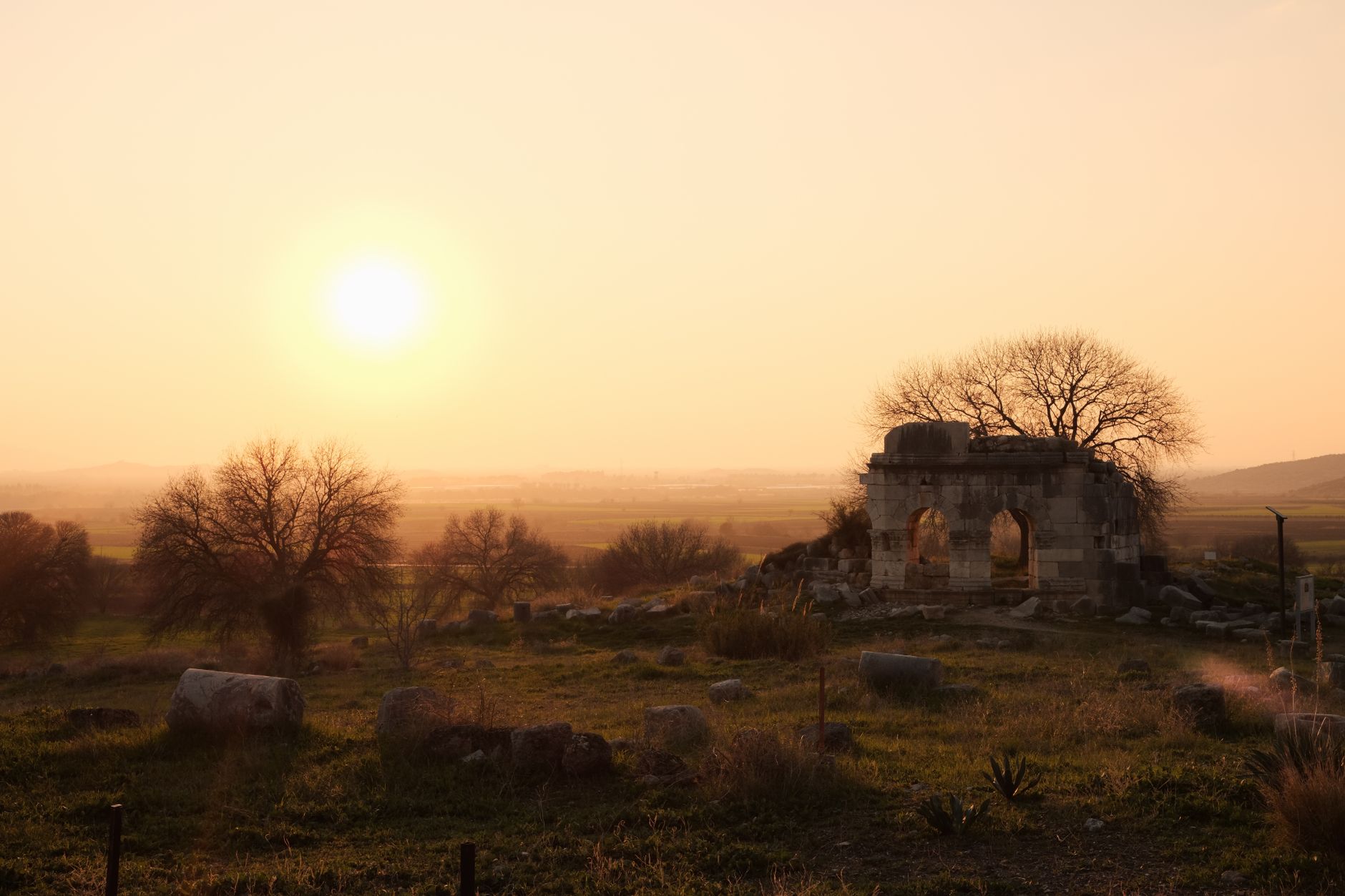 Golden light falling across the stone walls of mission ruins at dusk