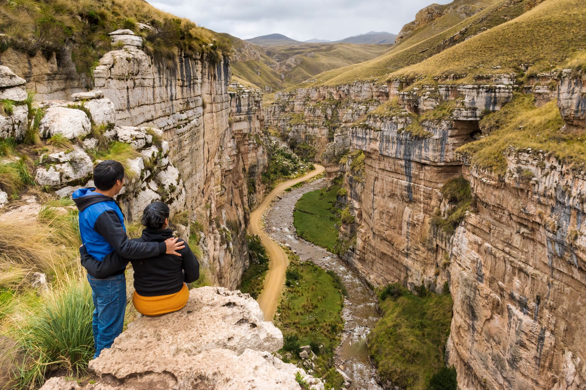 Deep canyon walls in the Peruvian Andes showing layered rock formations and terraced slopes