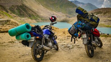 A motorbike rider navigating a steep mountain pass on a narrow road in northern Vietnam