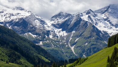 Wide alpine valley surrounded by snow-capped Tian Shan peaks in Kyrgyzstan