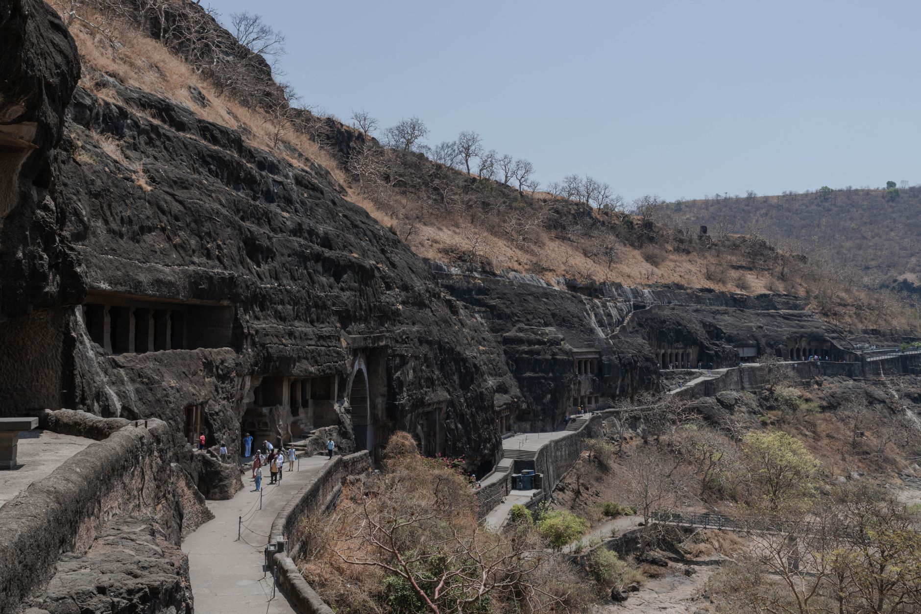 Ancient caves carved into vertical cliff faces in a remote Himalayan canyon