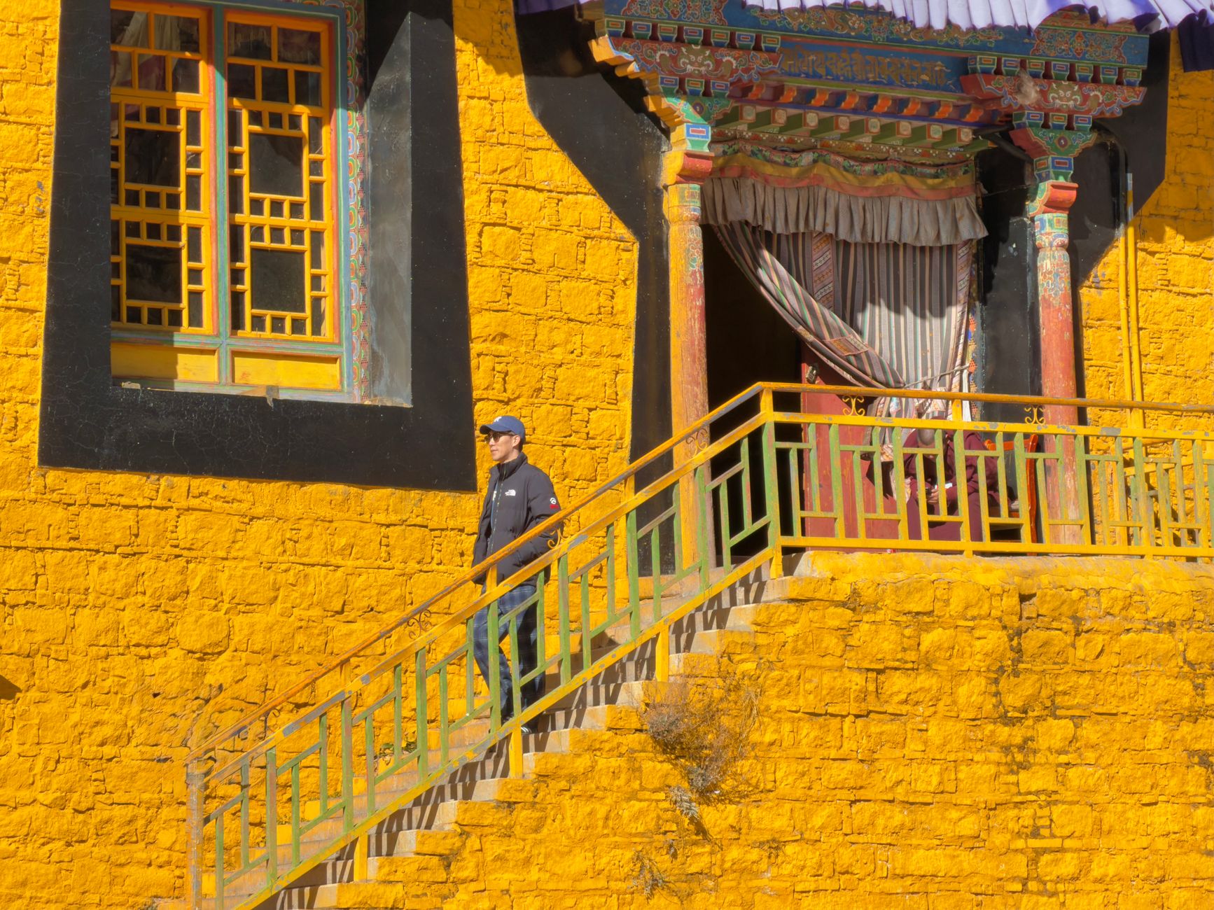 Whitewashed mud-brick walls of a Buddhist monastery in a high-altitude walled city