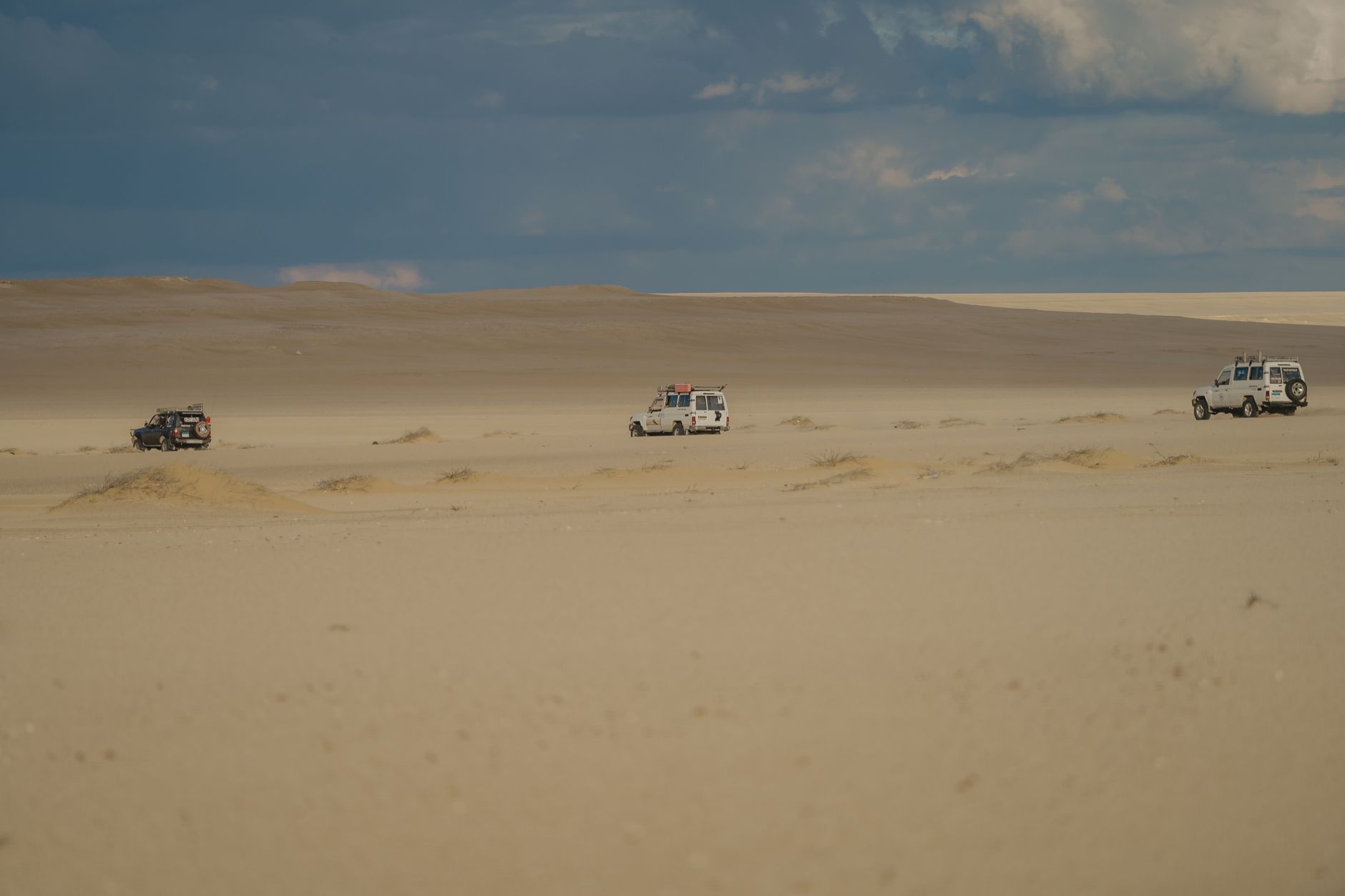Small safari boat moving slowly along a wide African river flanked by vegetation